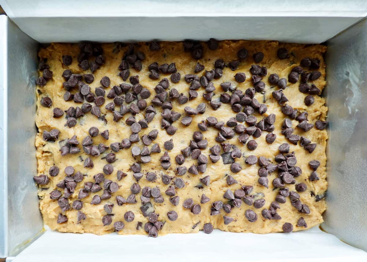 Chocolate Chip Marble Square Blondie Dough with chocolate chips on top before baking.