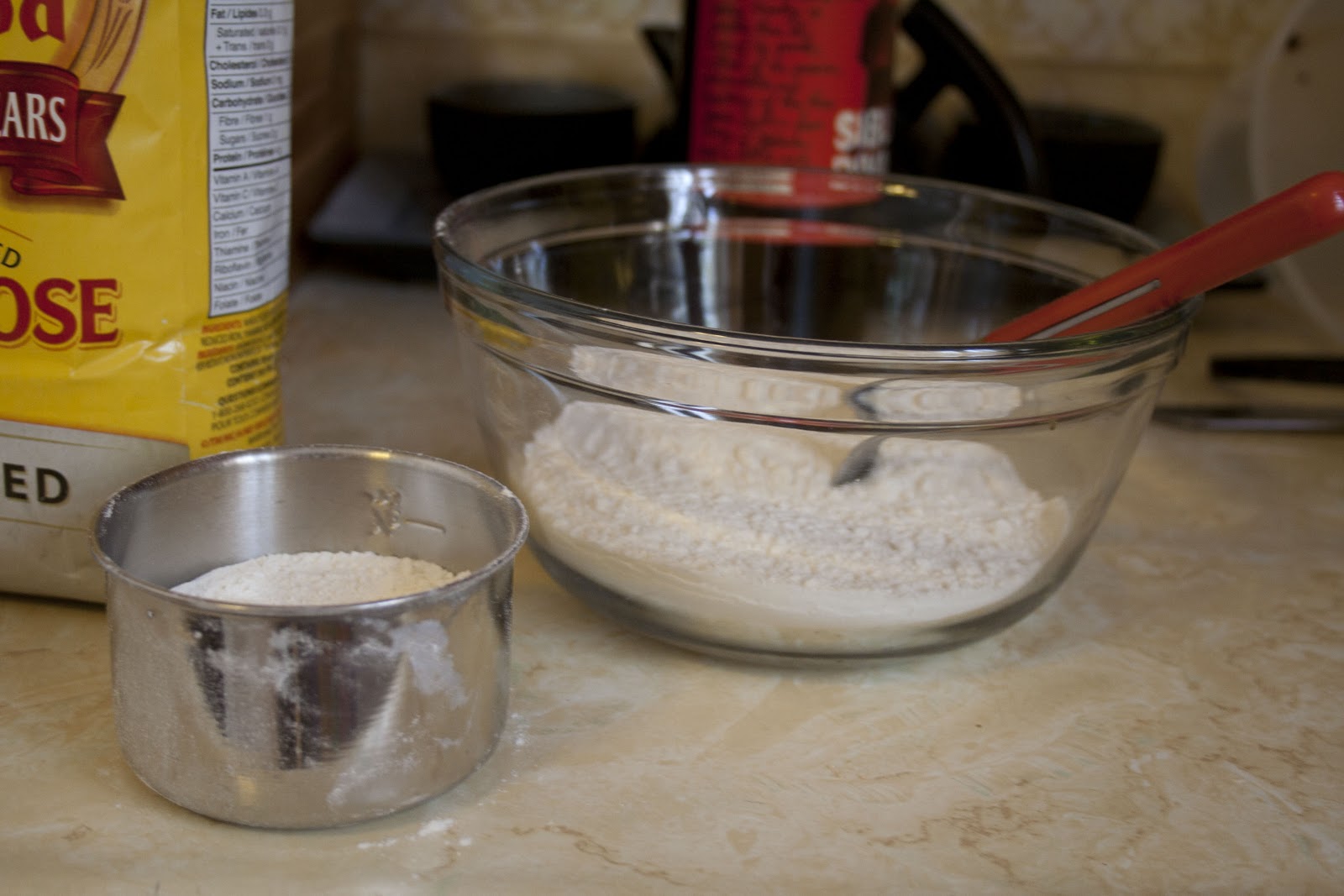 Measuring out 1 and a half cups of flour
