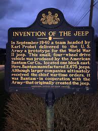 Blue and gold state historical marker - title reads The Invention of the Jeep
