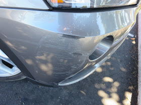 Close-up of bumper scrape before repairs at Almost Everything Auto Body.