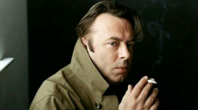 Christopher Hitchens smoking in overcoat