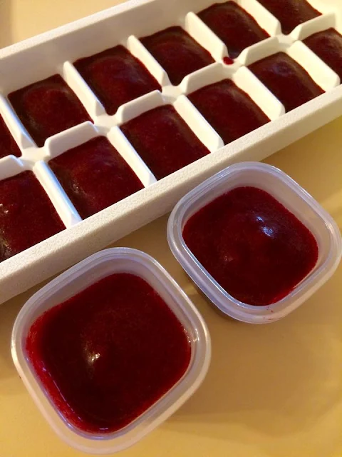 Homemade baby food puree in freezer containers.