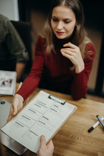 Picture shows a lady getting her resume reviewed