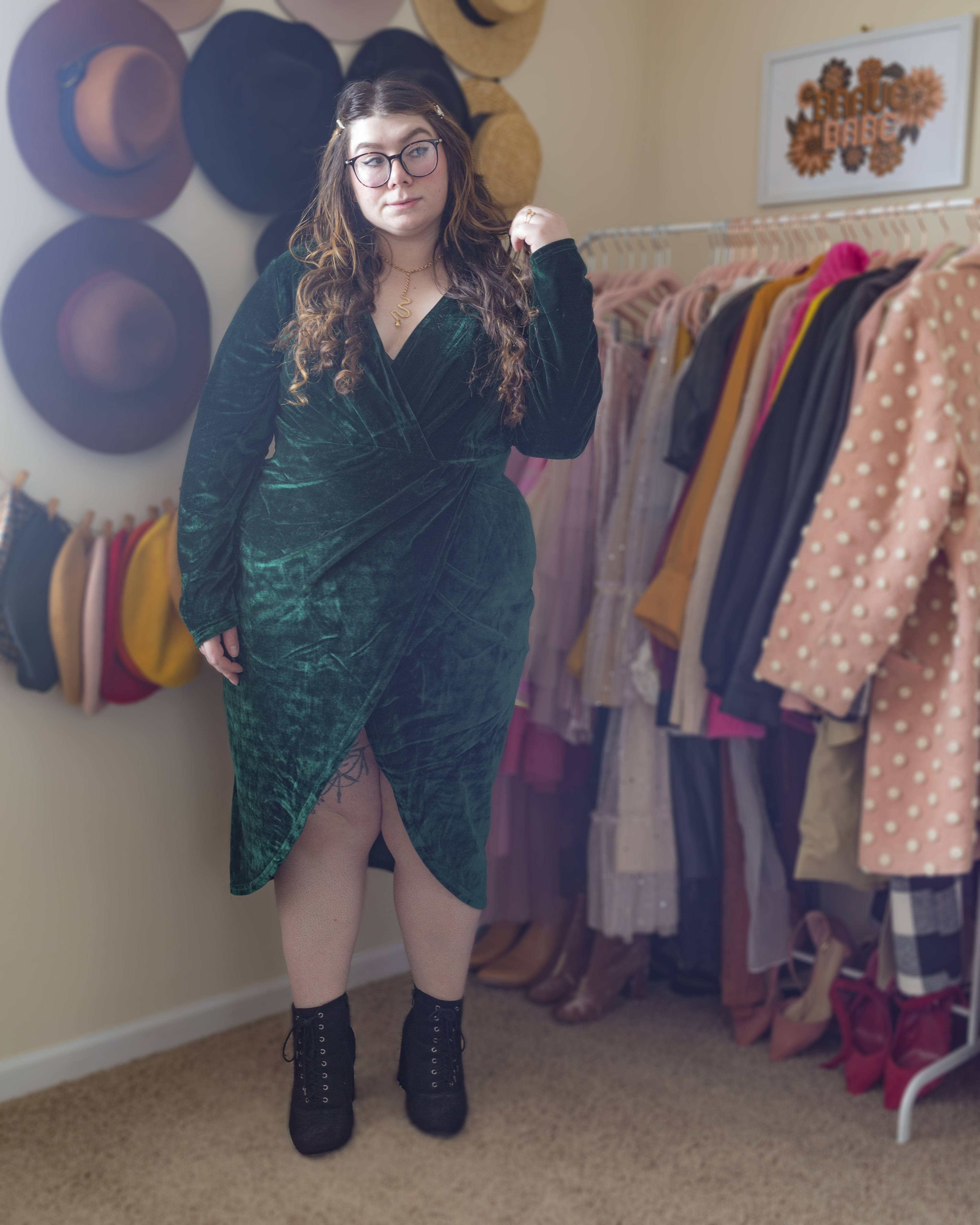 An outfit consisting of a forest green velvet low cut midi wrap dress, with black suede lace up boots.