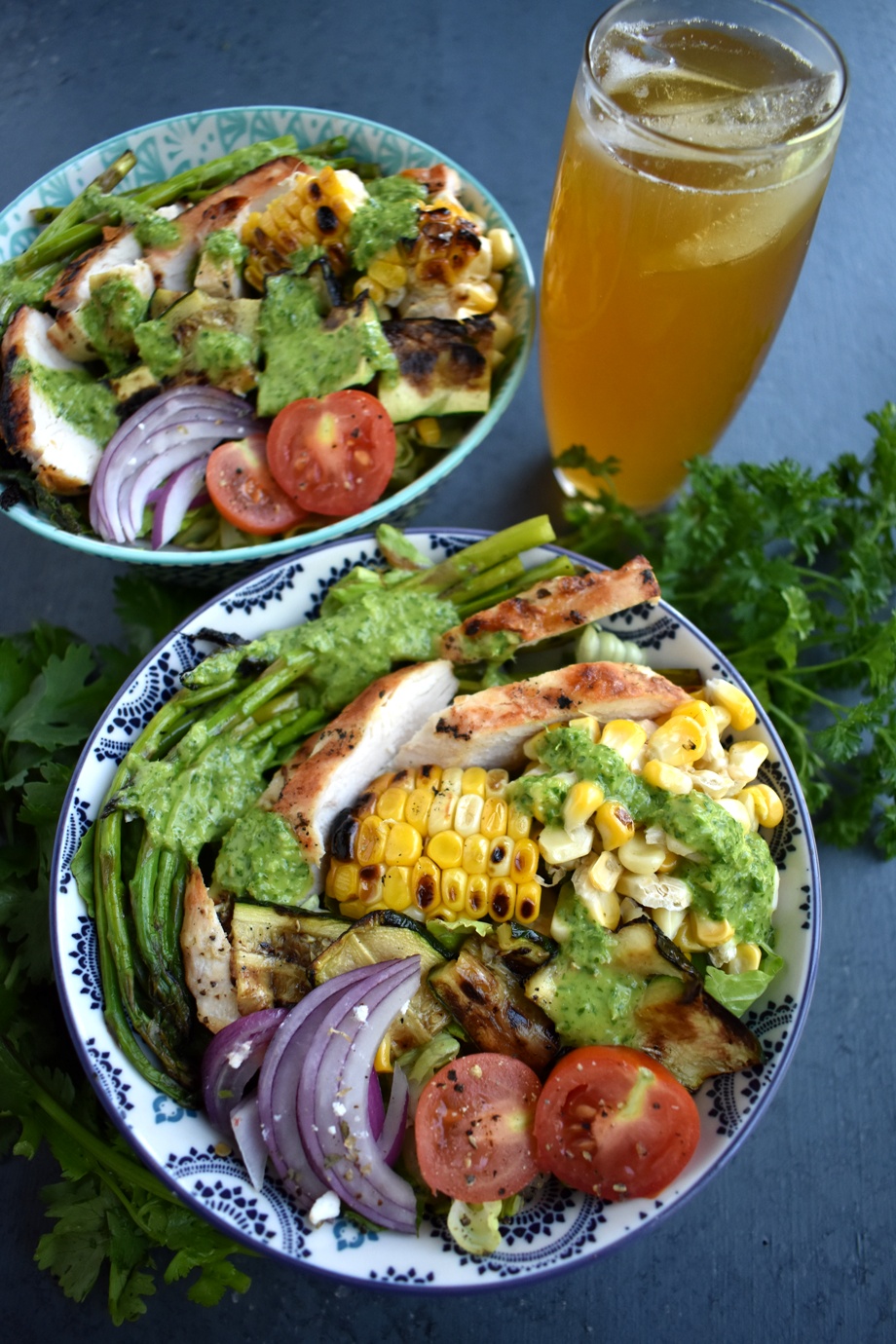 Chicken Chimichurri Salad is loaded with grilled chicken, corn, asparagus, zucchini, red onion and tomatoes and topped with a fresh parsley and cilantro herb chimichurri vinaigrette. www.nutritionistreviews.com