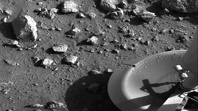Taken by the Viking 1 lander shortly after it touched down on Mars, this image is the first photograph ever taken from the surface of Mars. It was taken on July 20, 1976. The primary objectives of the Viking mission, which was composed of two spacecraft, were to obtain high-resolution images of the Martian surface, characterize the structure and composition of the atmosphere and surface and search for evidence of life on Mars. (Image Credit: NASA)