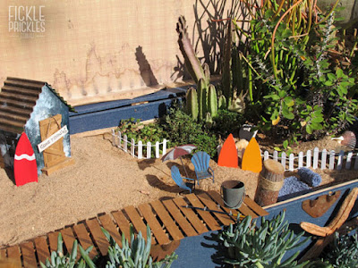 Succulent miniature garden beach scene in large chest