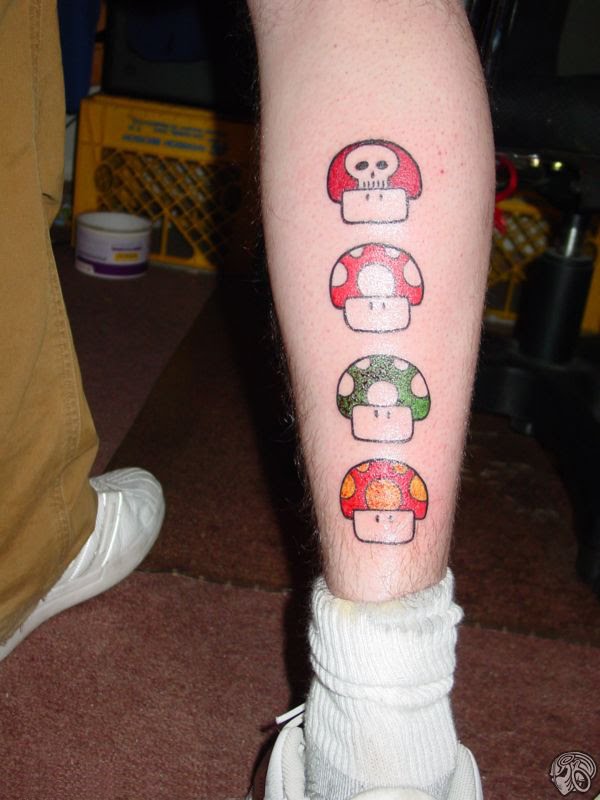 tattoos on back of leg. Mario mushrooms on ack of