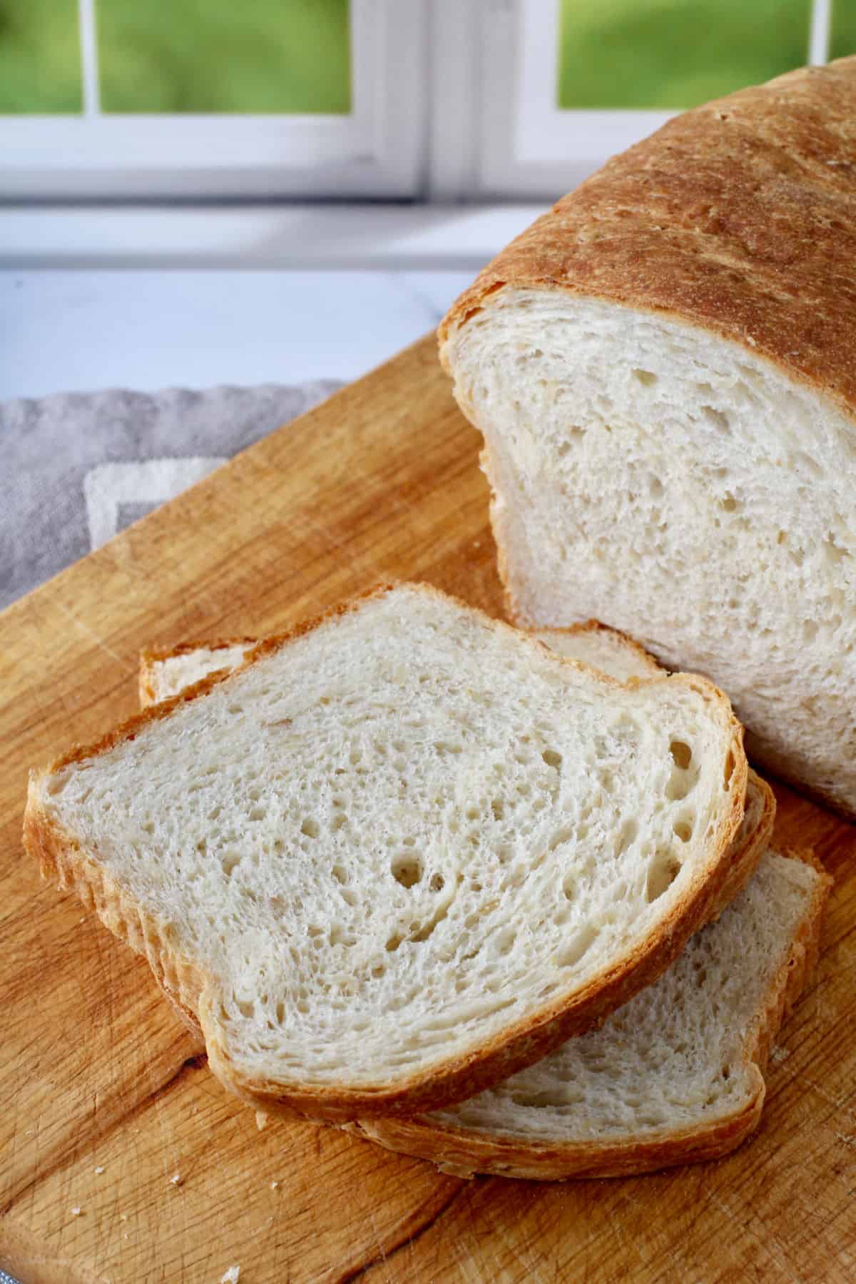 Honey Oatmeal Sandwich Bread slices on a cutting board.