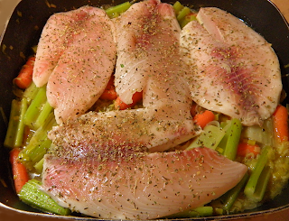 Pan with Four Raw Fish Fillets on Bed of Veggies