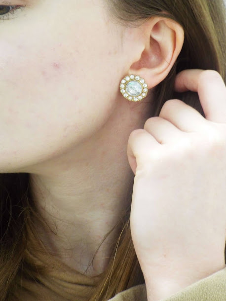 Close up shot of Ellie holding hair back to show Forever21 big diamante vintage earrings.