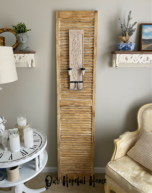tall rustic vintage shutter next to Bergere chair