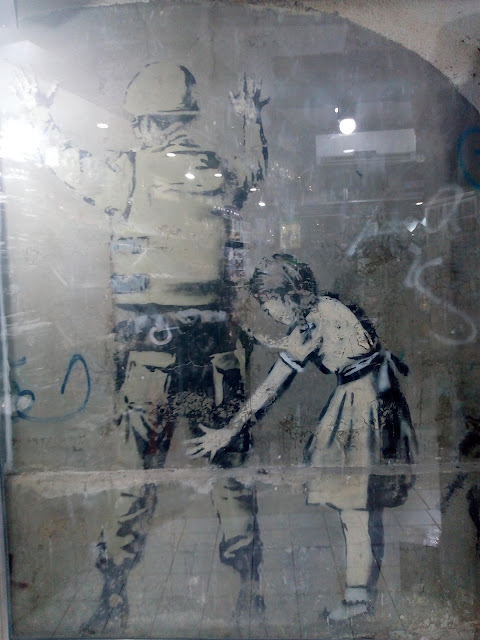 Girl Frisking Soldier, banksy