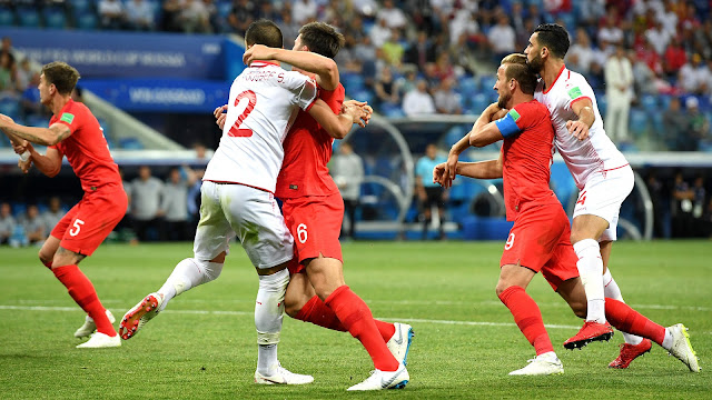 Tunisia players close marking on Harry Kane agains England