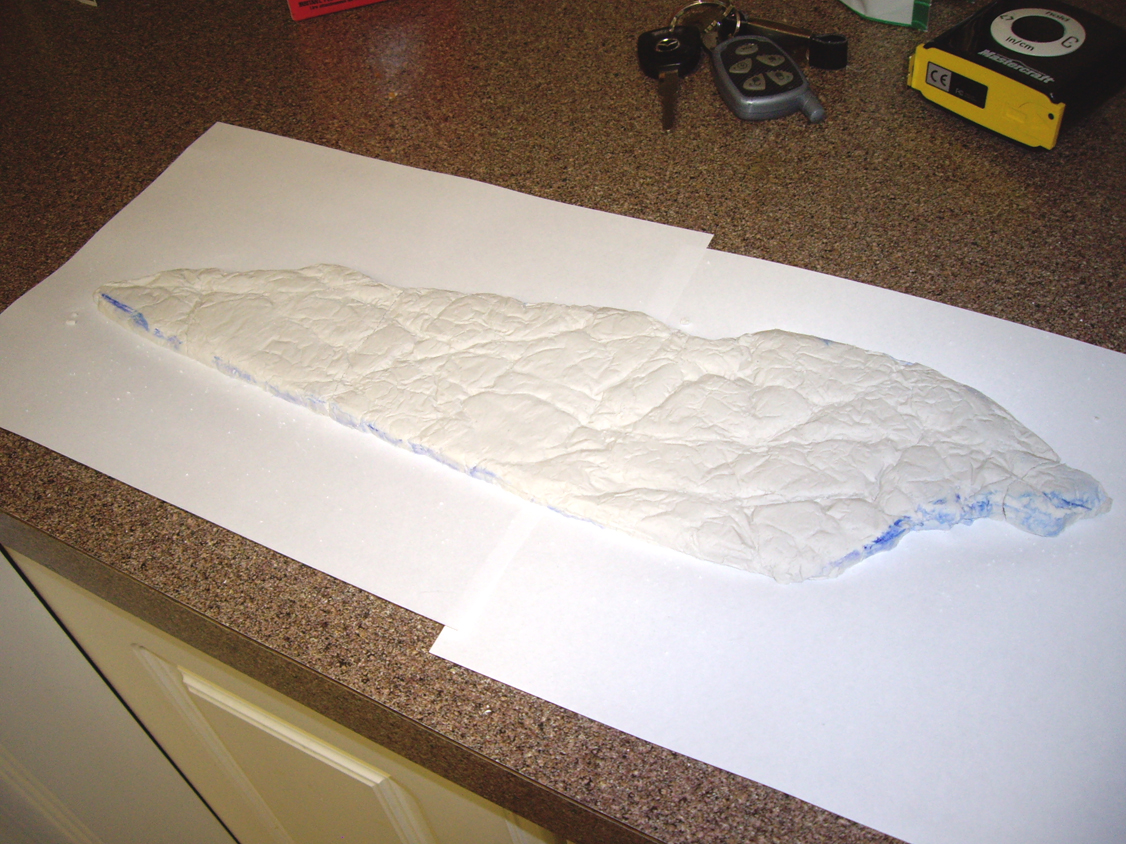 Shallow, triangular homemade plaster rock outcropping made from plaster of Paris