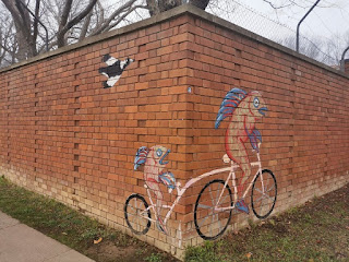 Fish riding bicycle mural in Dickson, ACT by Bev Hogg