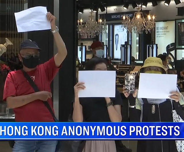 Proibido falar, hong konguesees protestam com folhas em branco.