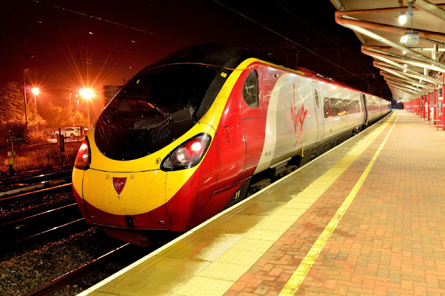 Colourful Night Photo of Pendolino Class 390128 electric multiple unit at rugby station England 2016