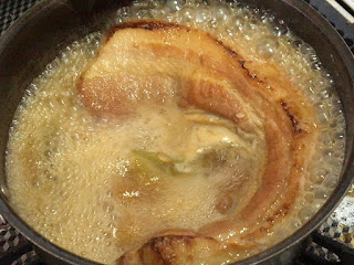 焼いた豚バラブロック肉を煮込んで味付け