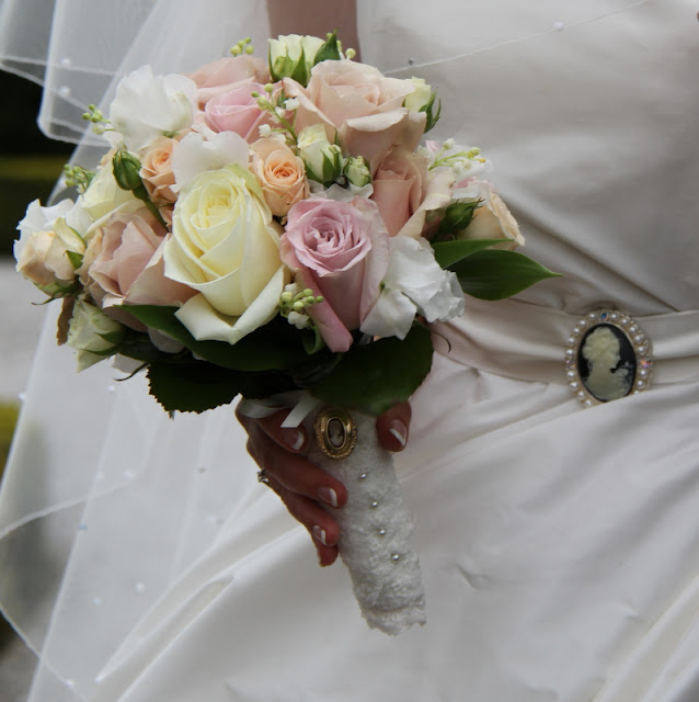  a cameo to compliment the cameo brooch on her classically elegant gown