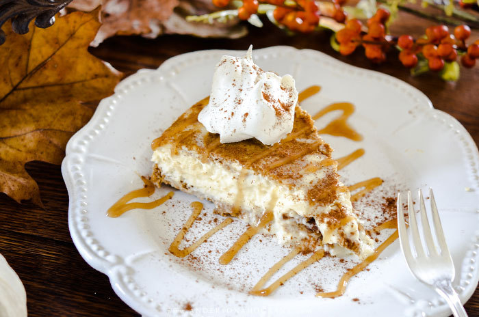 Slice of pumpkin cheesecake on white plate