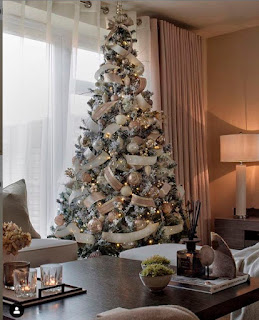 Christmas tree lavishly decorated with white toys