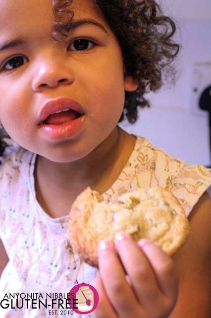 Girl eating a gluten-free chocolate chip cookie | Anyonita Nibbles Gluten-Free