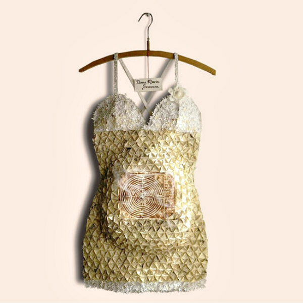 gold and white handmade paper dress hanging on wooden hanger