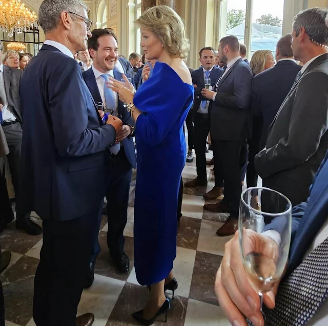 Queen Mathilde wore a royal blue midi dress by Natan. King Philippe hosted a reception for mayors of cities and municipalities