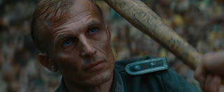 Nazi officer with the Bear Jew’s bat poised next to his head in the movie ‘Inglorious Basterds’