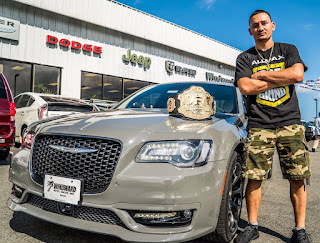 Kaimana's ex-husband Max posing for photo with a car