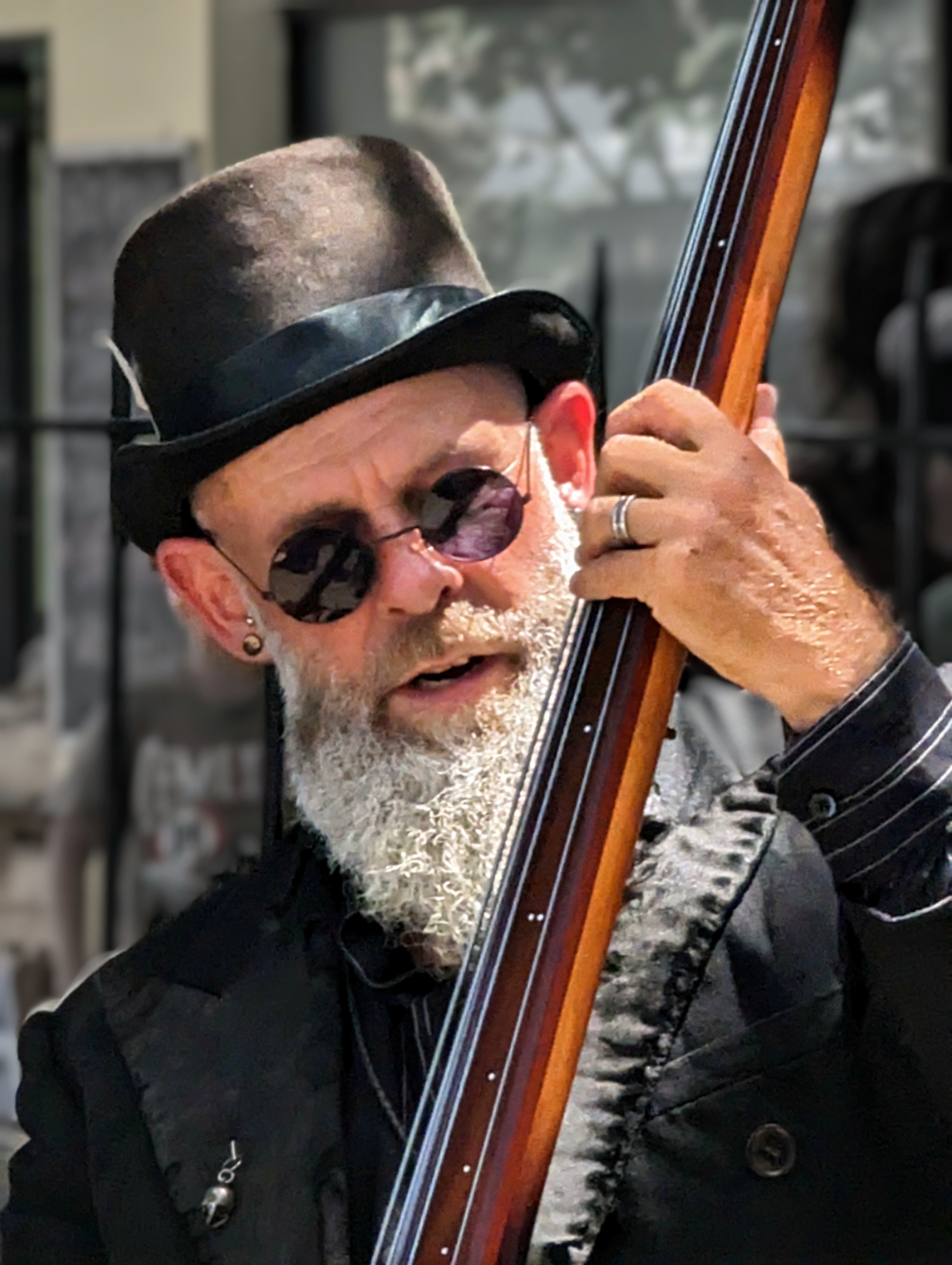 Grey beard, top hat, round glasses, and a sense of incredible style on this man as he plays his double bass out in the street (there was a whole band with him, out of shot).