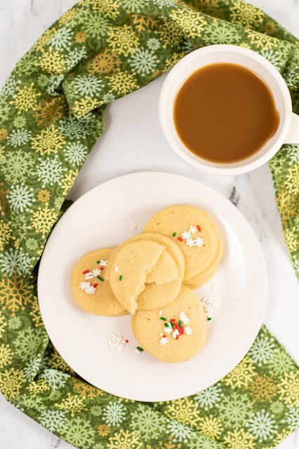 cookies on a plate with a cup of coffee.