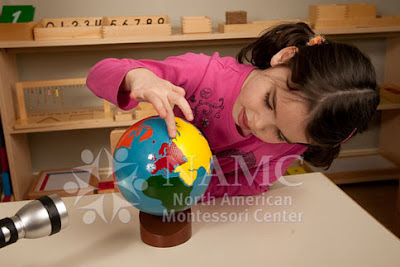 young girl works with NAMC montessori globe ideas for equinox activities