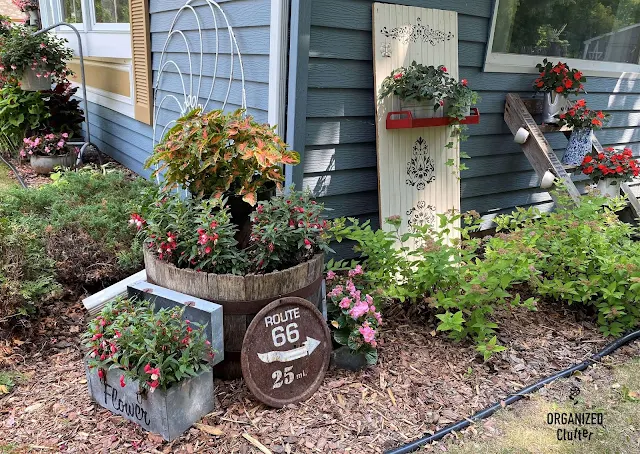 Photo of junk garden vignettes along the house