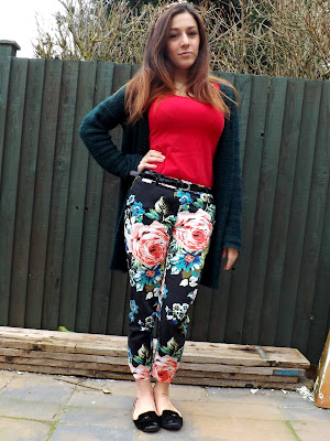 Person posing in floral trousers