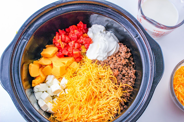 taco mac and cheese ingredients in slow cooker before being cooked.