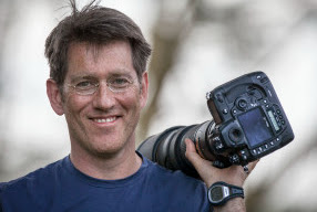 Picture of Roger Fishman carrying a camera