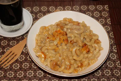 Stout macaroni and cheese in a serving bowl.