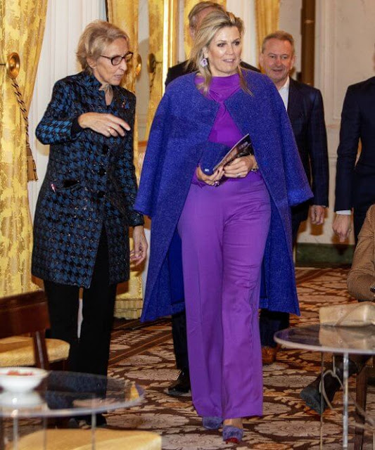 Purple silk blouse and purple trousers. JAR Paris amethyst and diamond earrings. Natan coat. Christian Louboutin purple pumps