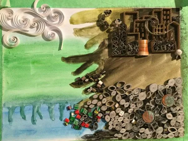 quilled landscape in progress showing watercolor background of water, land, and sky with quilled coils