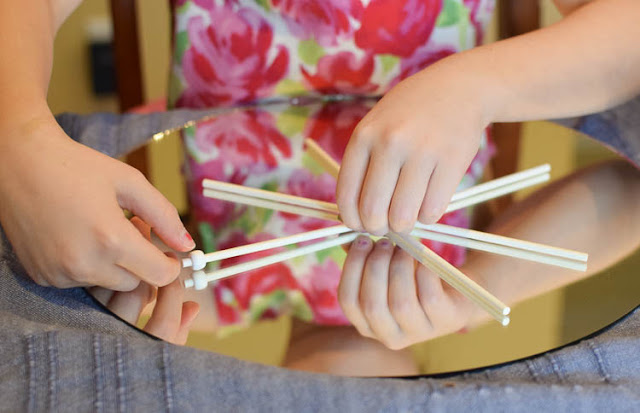 Winter STEM- Build A Snowflake Tinker Tray.  Use loose parts to build snowflakes.  Explore radial symmetry as you incorporate math, science, fine motor work, and creativity in this activity for preschoolers, kindergartners, and elementary school.