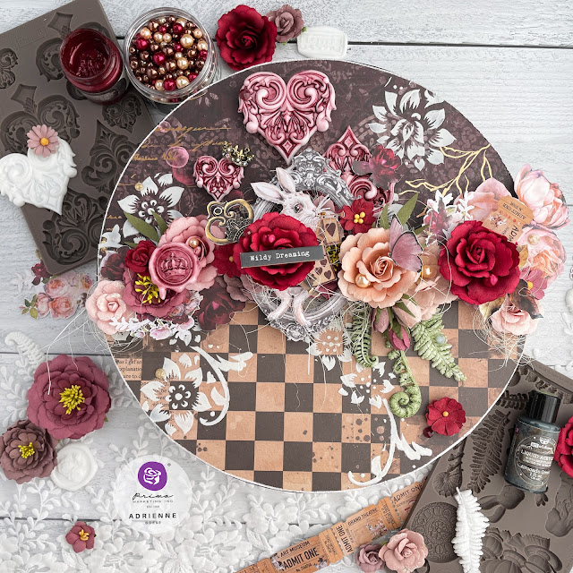 Queen of Hearts inspired mixed media art on a 12 inch wooden circle, decorated with Prima Marketing Lost in Wonderland ephemera, papers, flowers and moulds; as well as with Finnabair art mediums.
