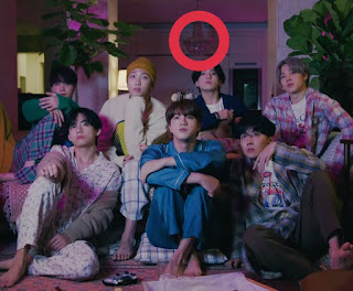 capture from BTS Life Goes On MV music video. BTS inside their dorm in HannanTheHill in the living room sitting on the sofa. dining room's lamp in a red circle