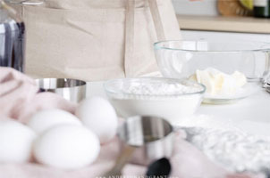 ingredients in glass bowls and eggs on counter