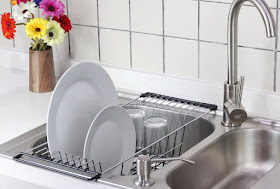 dish rack that rests over the sides of the sink, with the rack dipping down into the sink