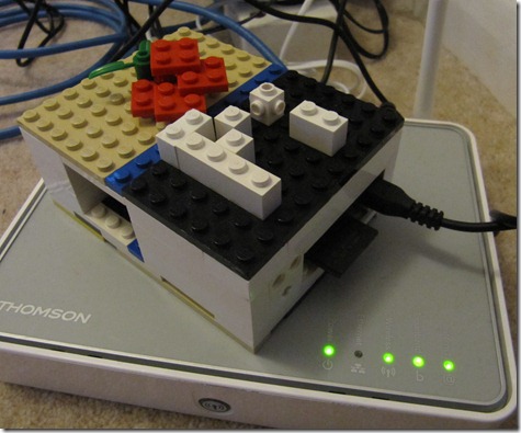 Raspberry Pi in Lego case connected to a router