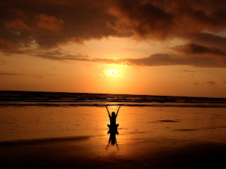 meditating on a beach at sunrise