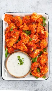 tandoori cauliflower in a serving plate with sauce