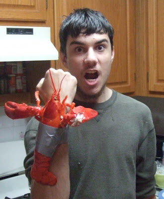 Photograph of a brilliant young man with a lobster duct-taped to his forearm